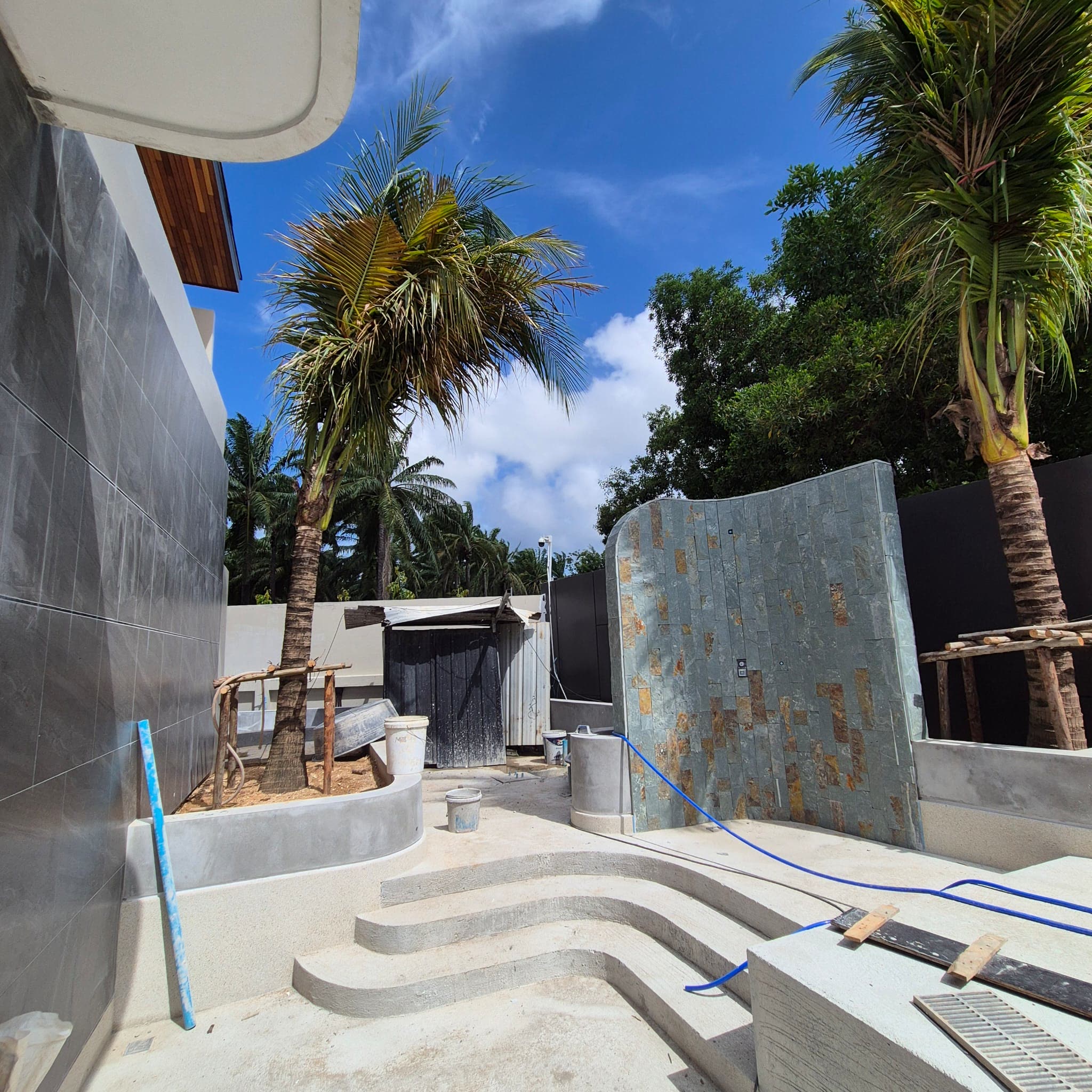 Pool steps and stone feature wall